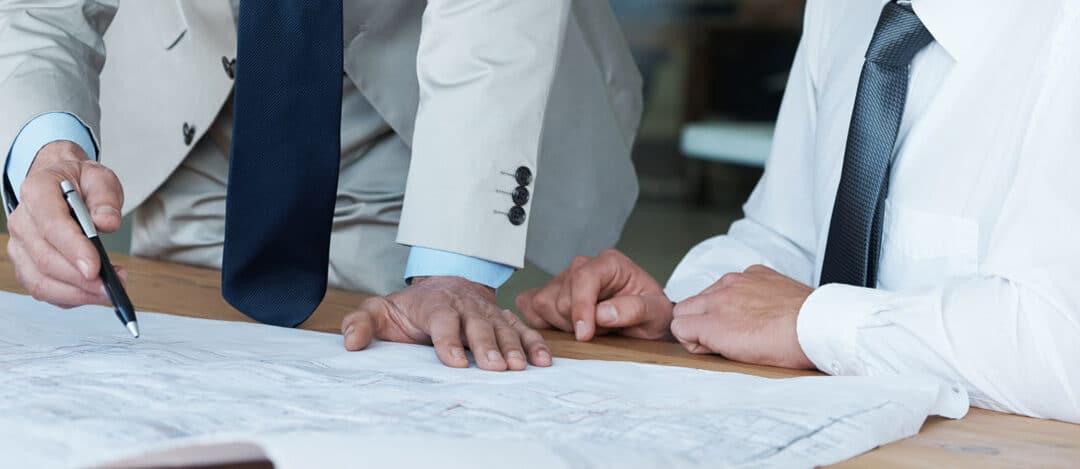 Two People Looking Over Engineering Drawings